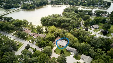 an aerial view of a house with outdoor space and lake view