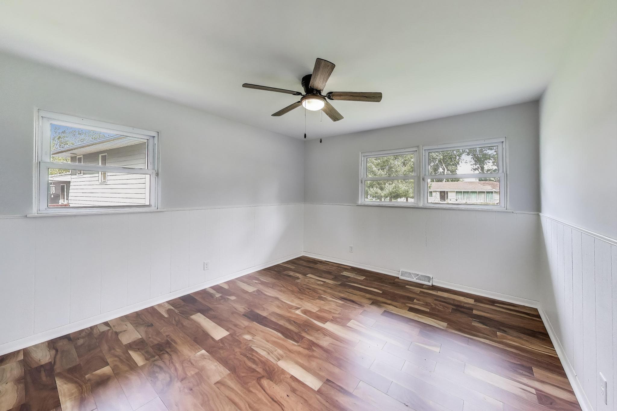 1009 Lake George Drive Hobart, IN 46342 - Photo 32 of 73 a view of empty room with wooden floor and fan