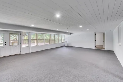 an empty room with a empty space and windows