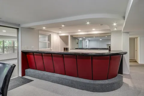 a view of backyard with green space and wooden fence
