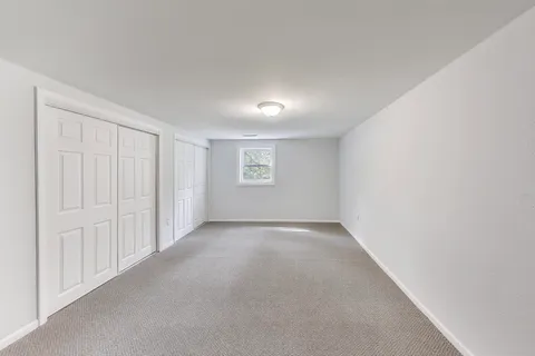 a view of a house with a yard and potted plants