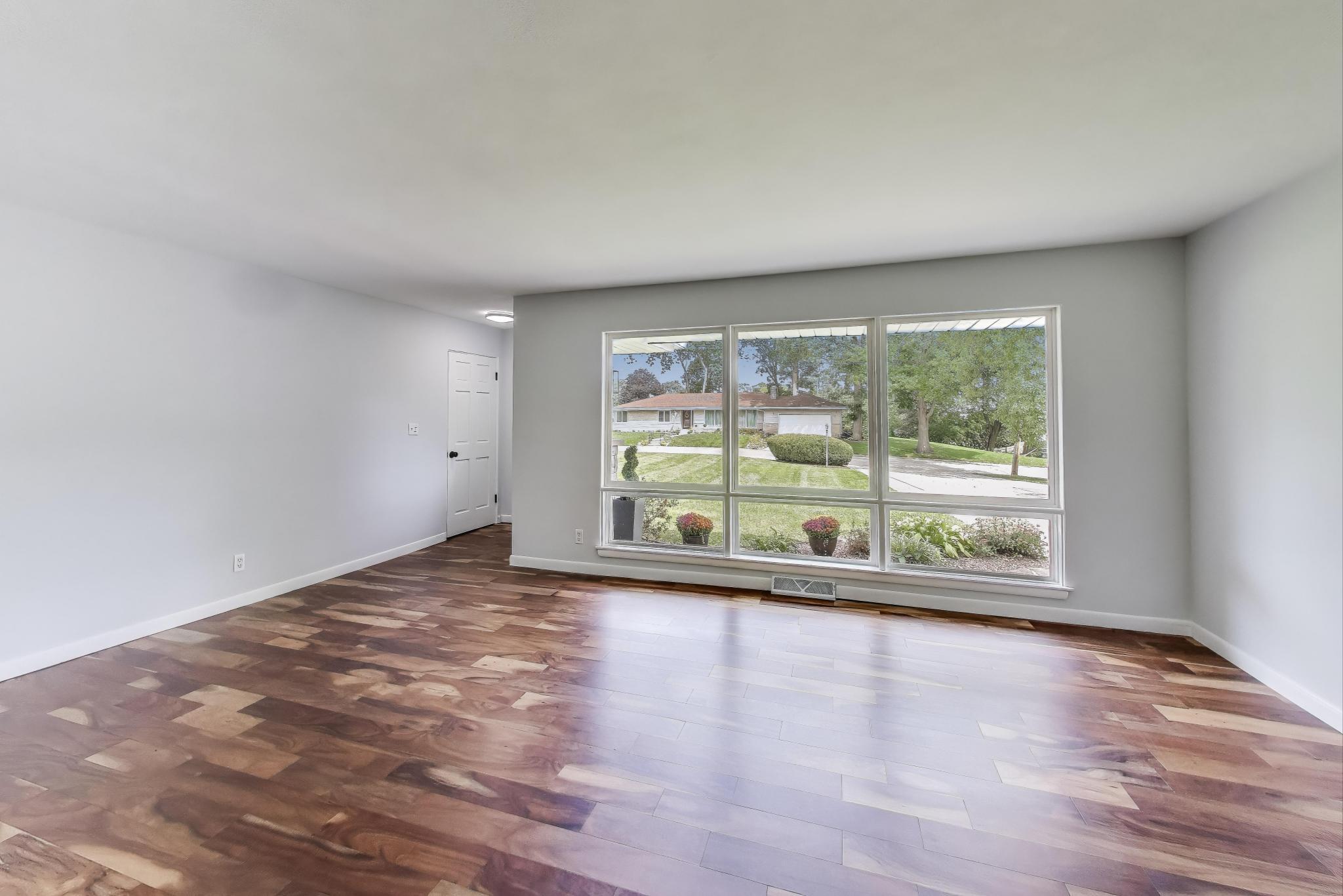 1009 Lake George Drive Hobart, IN 46342 - Photo 7 of 73 a view of an empty room with wooden floor and a window