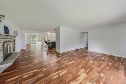 a living room with furniture a chandelier and a flat screen tv
