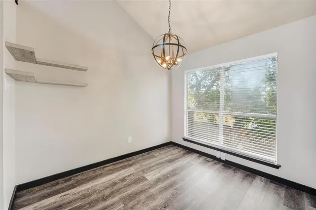 a view of a room with wooden floor and windows