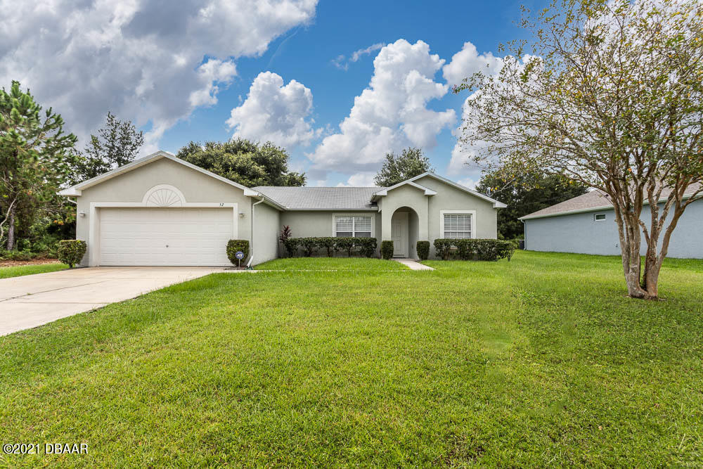 52 Underwick Path Palm Coast, FL 32164 - Photo 1 of 21 a front view of a house with garden