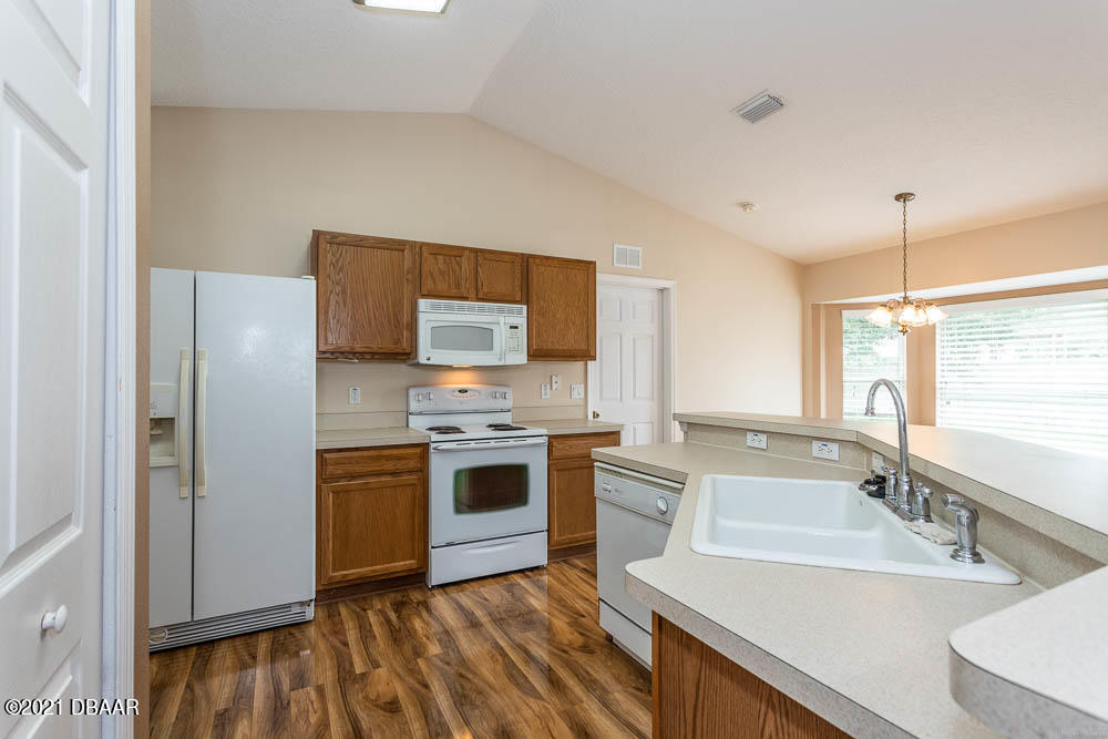52 Underwick Path Palm Coast, FL 32164 - Photo 11 of 21 a kitchen with a sink stove and refrigerator