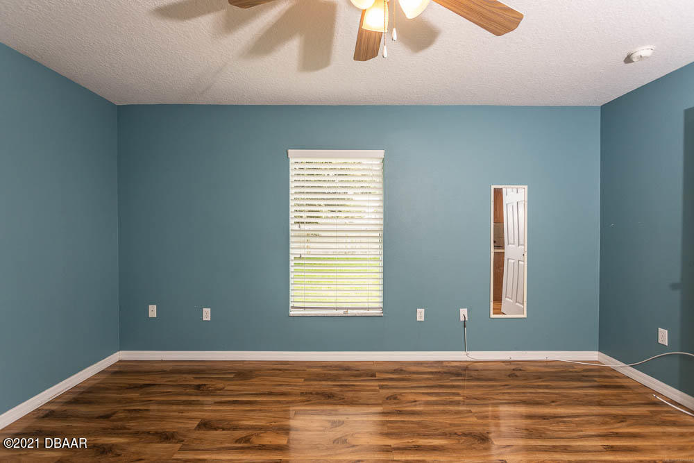 52 Underwick Path Palm Coast, FL 32164 - Photo 12 of 21 a view of an empty room with window and wooden floor