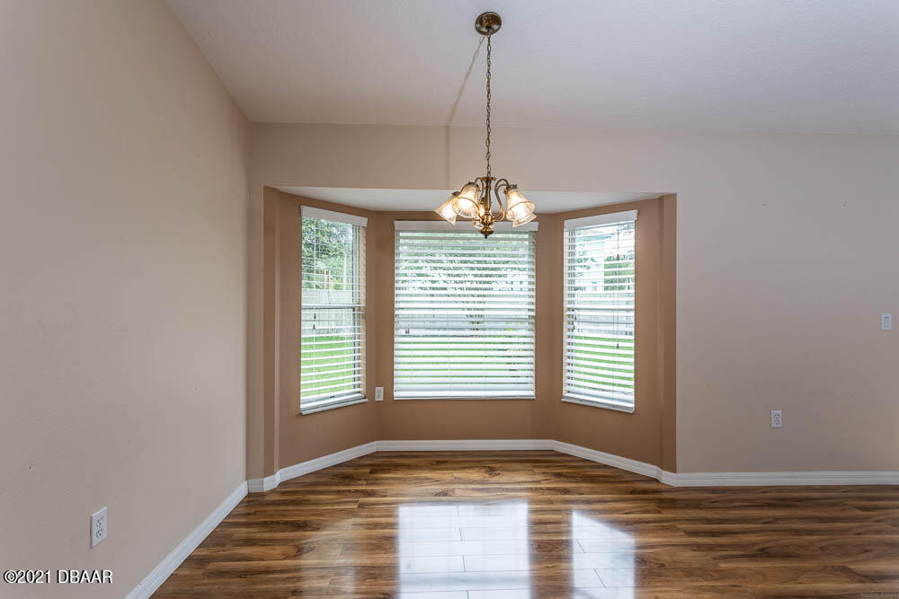 52 Underwick Path Palm Coast, FL 32164 - Photo 6 of 21 a view of empty room with wooden floor and fan