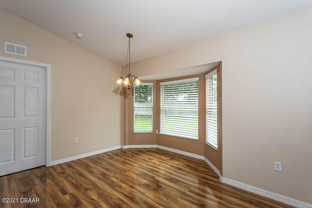 52 Underwick Path Palm Coast, FL 32164 - Photo 7 of 21 a view of empty room with wooden floor and fan