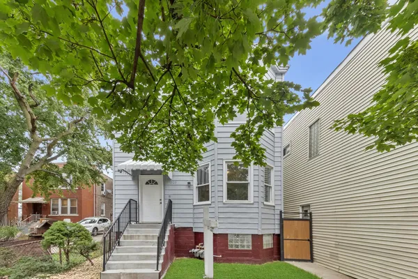 front view of a house with a tree