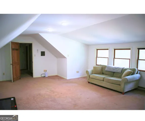 a living room with furniture and a piano
