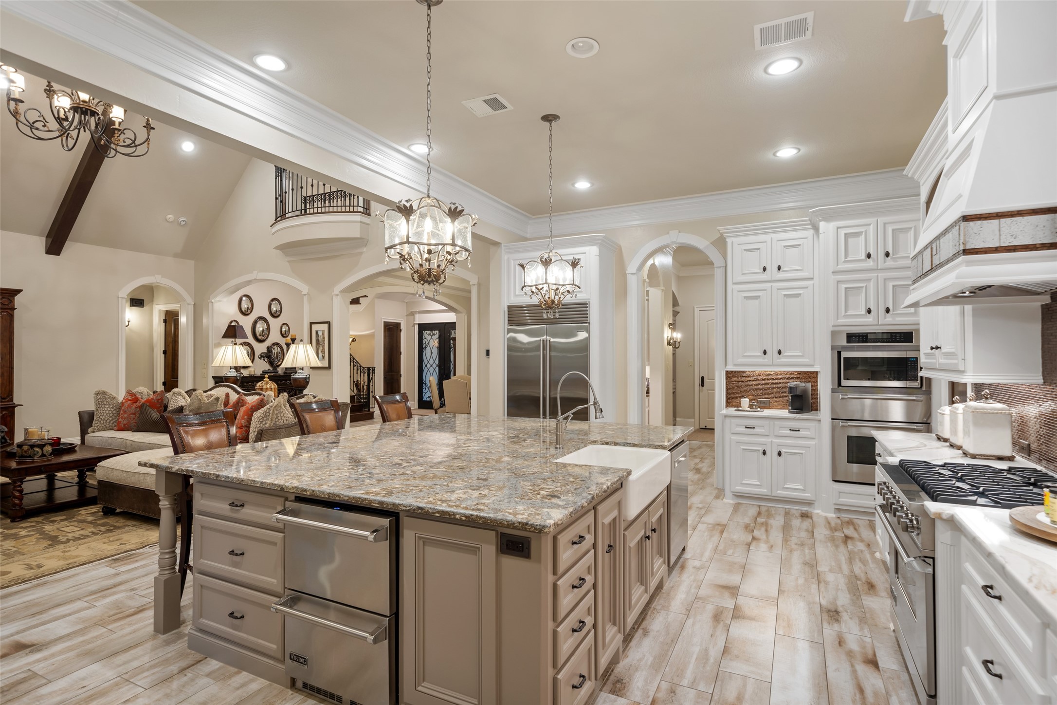 59 East Ambassador Bend Spring, TX 77382 - Photo 47 of 48 Another perspective of the spacious kitchen. The open floor plan and effortless flow are evident in this photo. This view reveals the built-in Sub-Zero refrigerator, Viking beverage drawers, Viking gas range, two ovens and warming drawer.