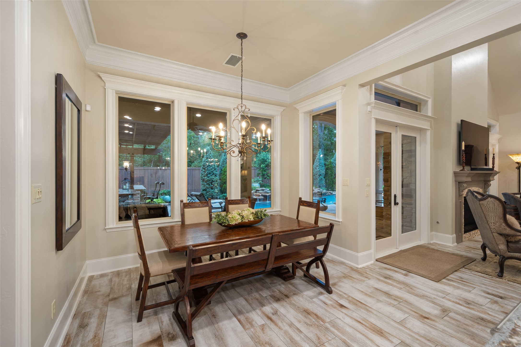 59 East Ambassador Bend Spring, TX 77382 - Photo 12 of 48 Enjoy your coffee while peering out over the pool and spa from this bright and inviting breakfast nook. Its wall of windows frame peaceful views of the picturesque scene. This light-filled space offers a comfortable setting for casual dining, enhanced by effortless access to the main living area for easy everyday use.
