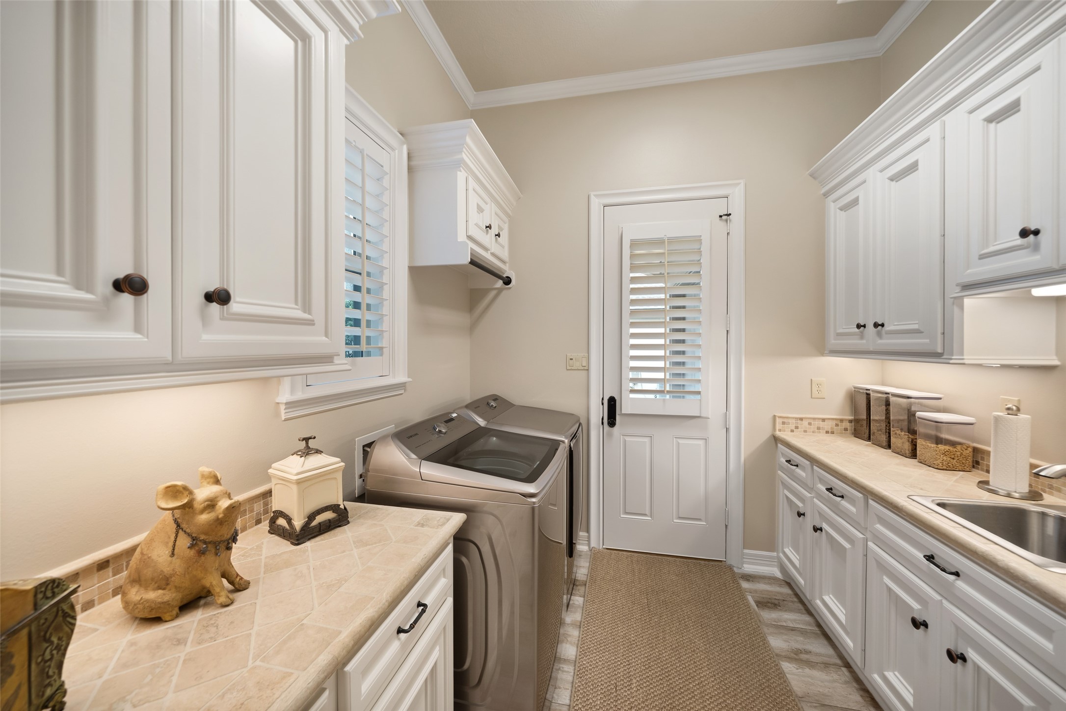 59 East Ambassador Bend Spring, TX 77382 - Photo 15 of 48 Steps away from the kitchen is this spacious, well-designed modern laundry room with a clean, functional layout and abundant storage. It enjoys natural light and a pedestrian door to the motor court.