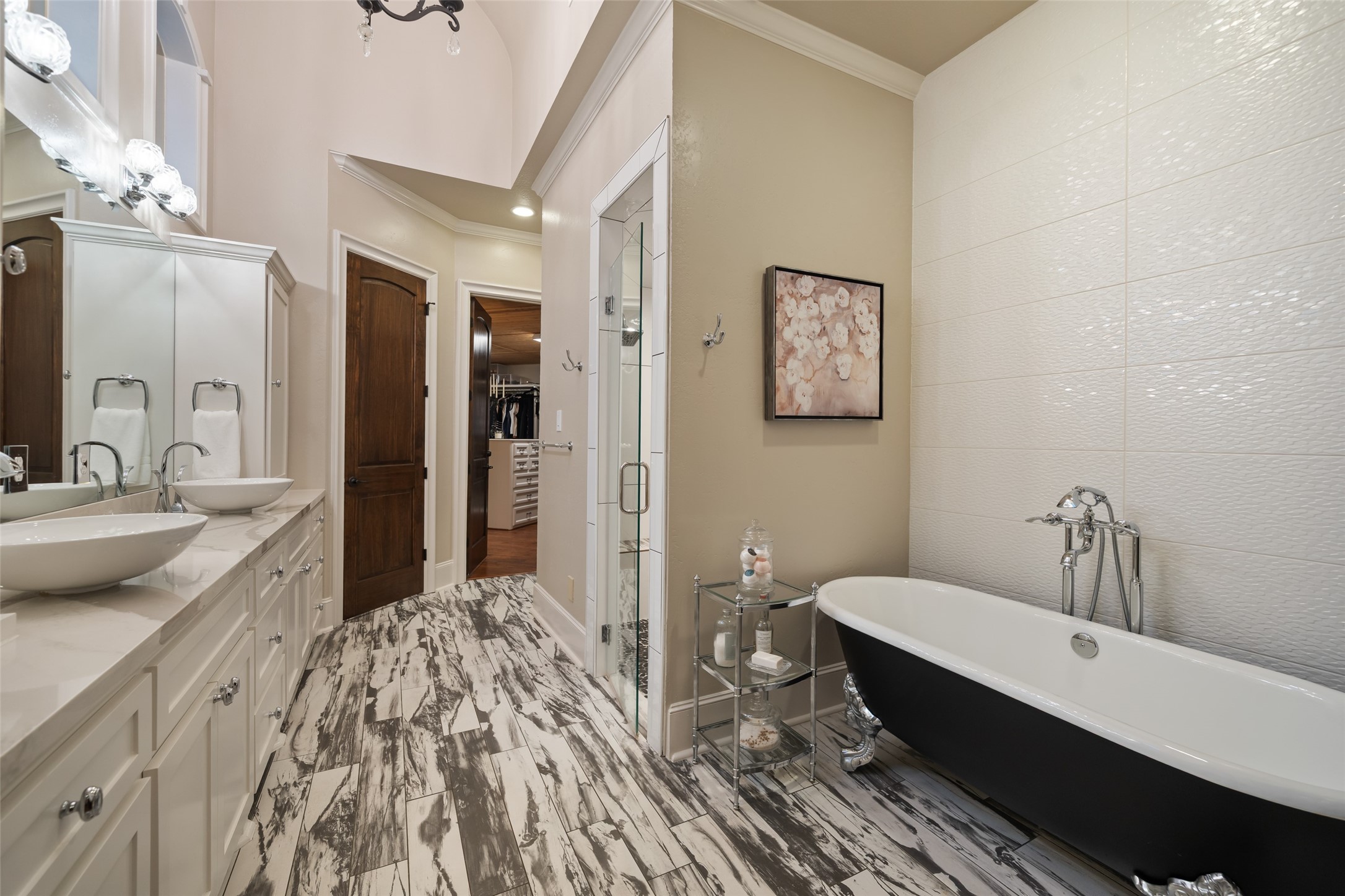 59 East Ambassador Bend Spring, TX 77382 - Photo 17 of 48 This updated primary bathroom feels like a spa retreat, featuring a luxurious clawfoot tub, double sinks, abundant cabinetry and a separate spacious walk-in shower.