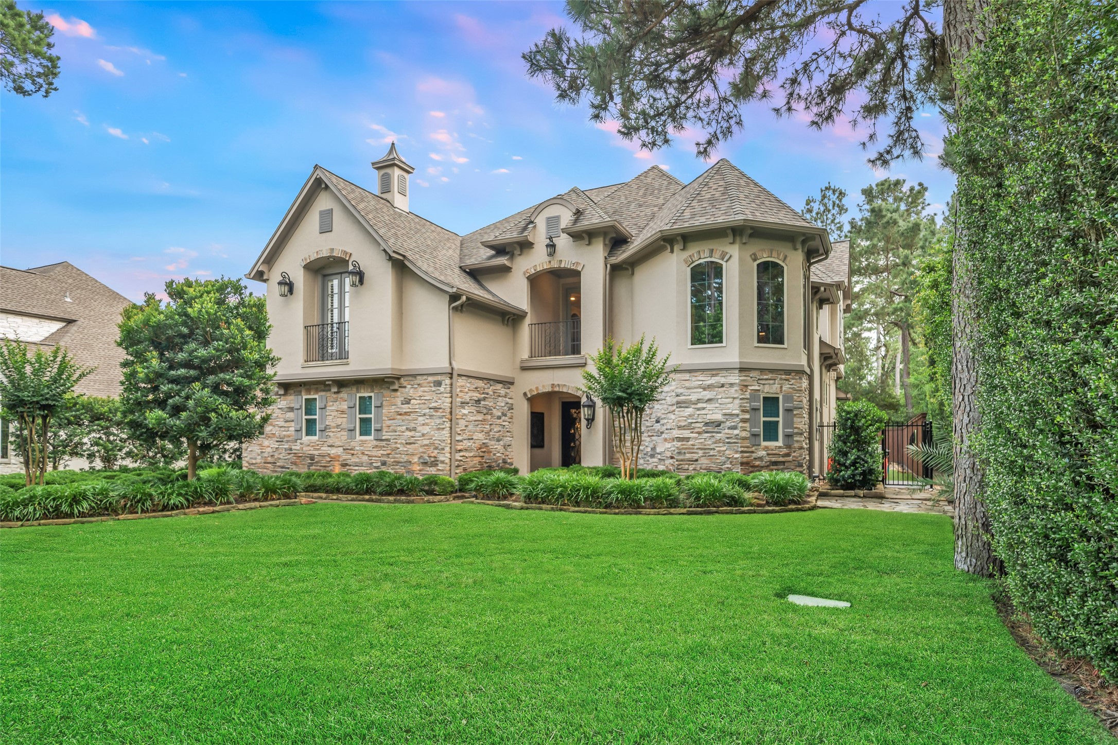 59 East Ambassador Bend Spring, TX 77382 - Photo 46 of 48 Tucked away on a corner lot with no rear neighbors and just steps away from the WCC Gary Player Golf Course, this classic stucco & stone residence exudes timeless elegance. Custom built by Meadowlark Homes, the property showcases a neutral color palette and an open-concept floorplan.