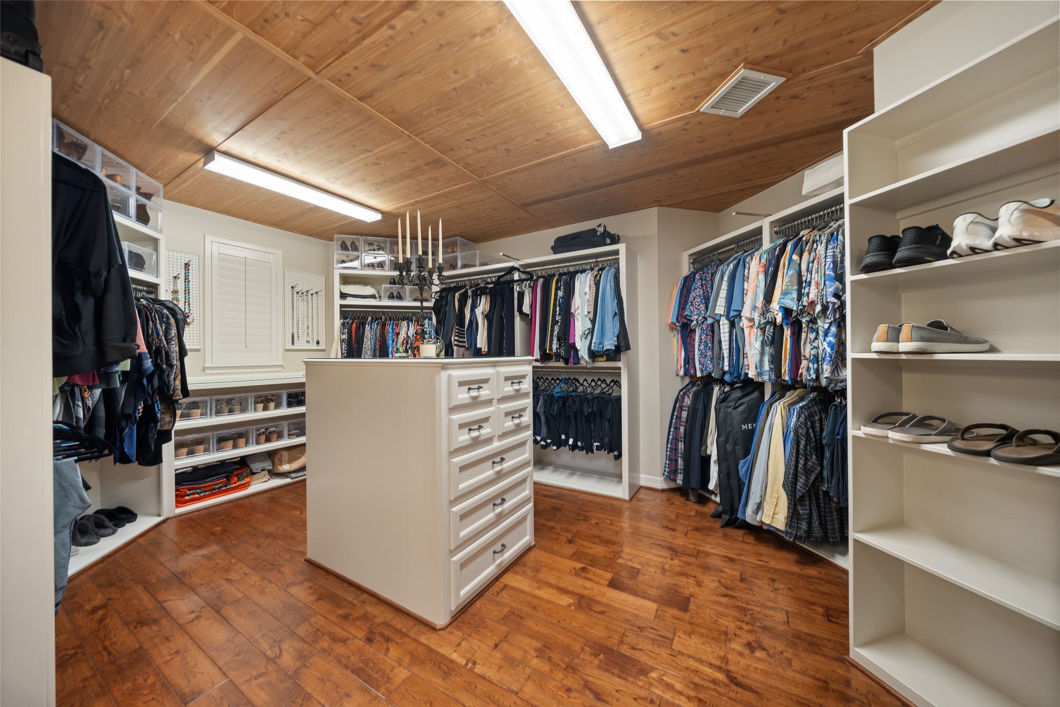 59 East Ambassador Bend Spring, TX 77382 - Photo 19 of 48 The expansive primary closet is truly impressive, offering an abundance of built-ins and generous hanging space. The closet was thoughtfully designed for both organization and convenience. Its cedar ceiling emits a fresh natural scent while protecting garments.