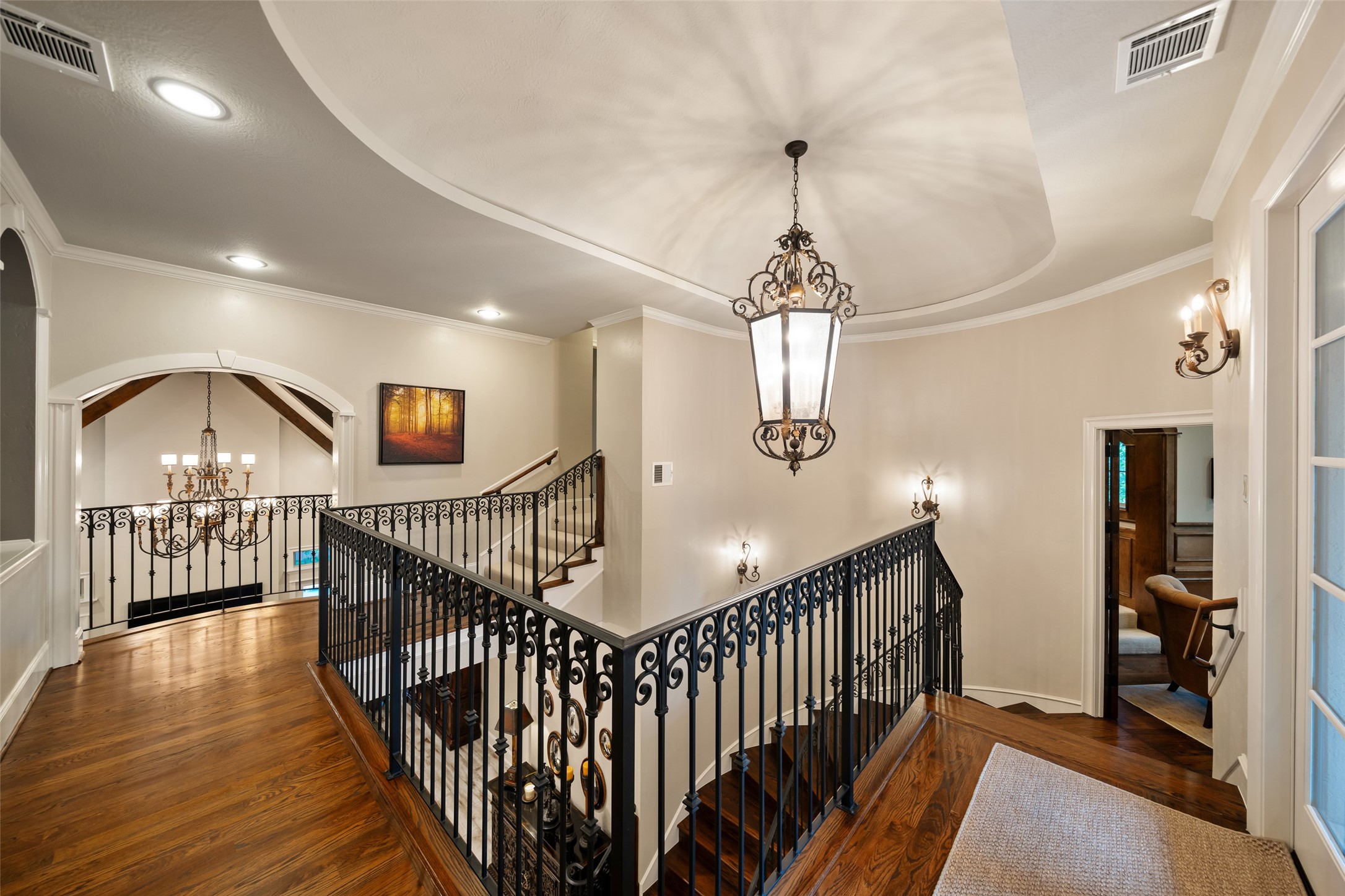 59 East Ambassador Bend Spring, TX 77382 - Photo 22 of 48 Ascending to the second level, the landing features handsome wood floors and wrought iron balusters, as well as open views of the home's architecture.