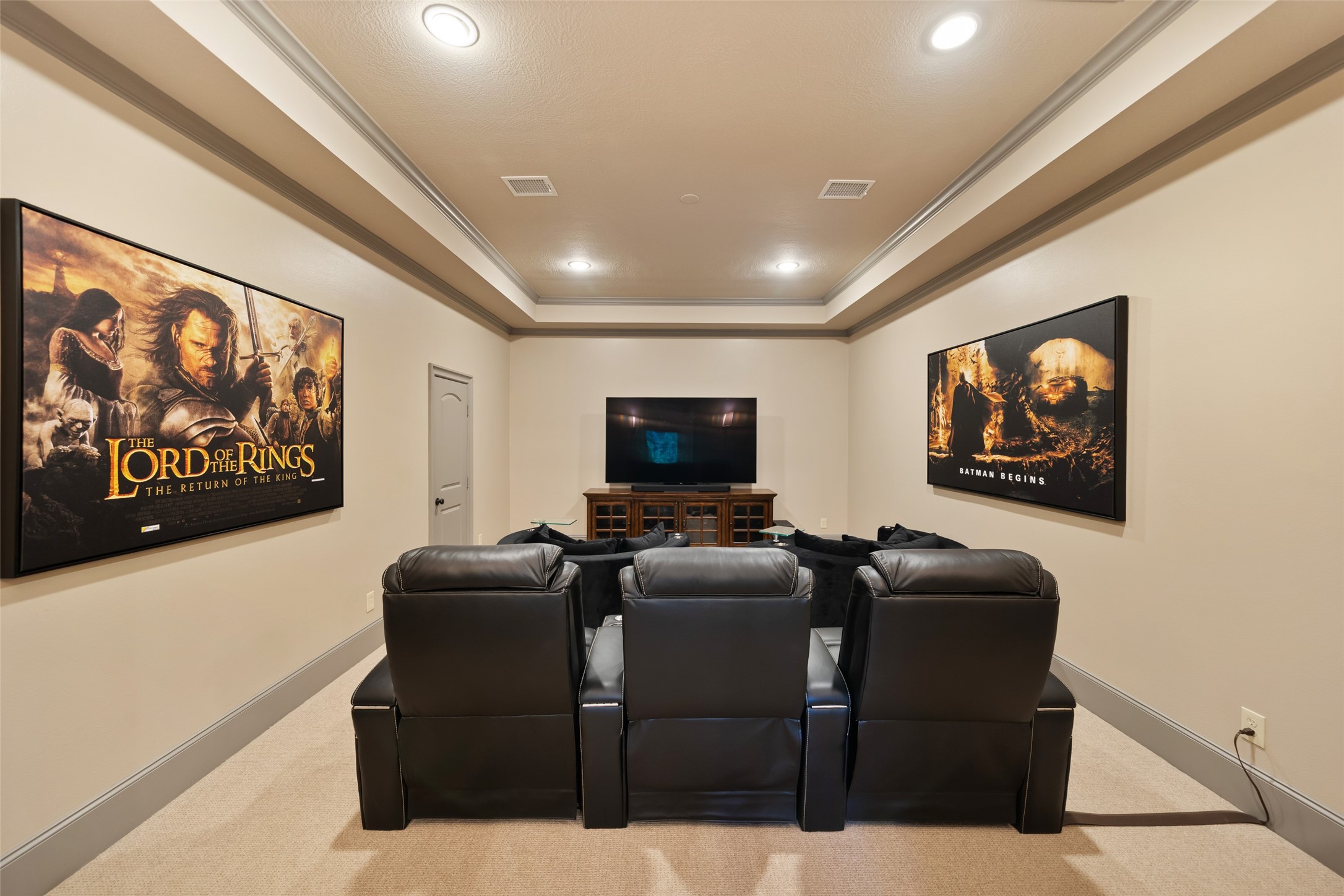 59 East Ambassador Bend Spring, TX 77382 - Photo 27 of 48 A large media room features tray ceilings, soft ambient lighting, and clean architectural lines that create a spacious, theater-like atmosphere. The plush wool carpeting softens the sound.