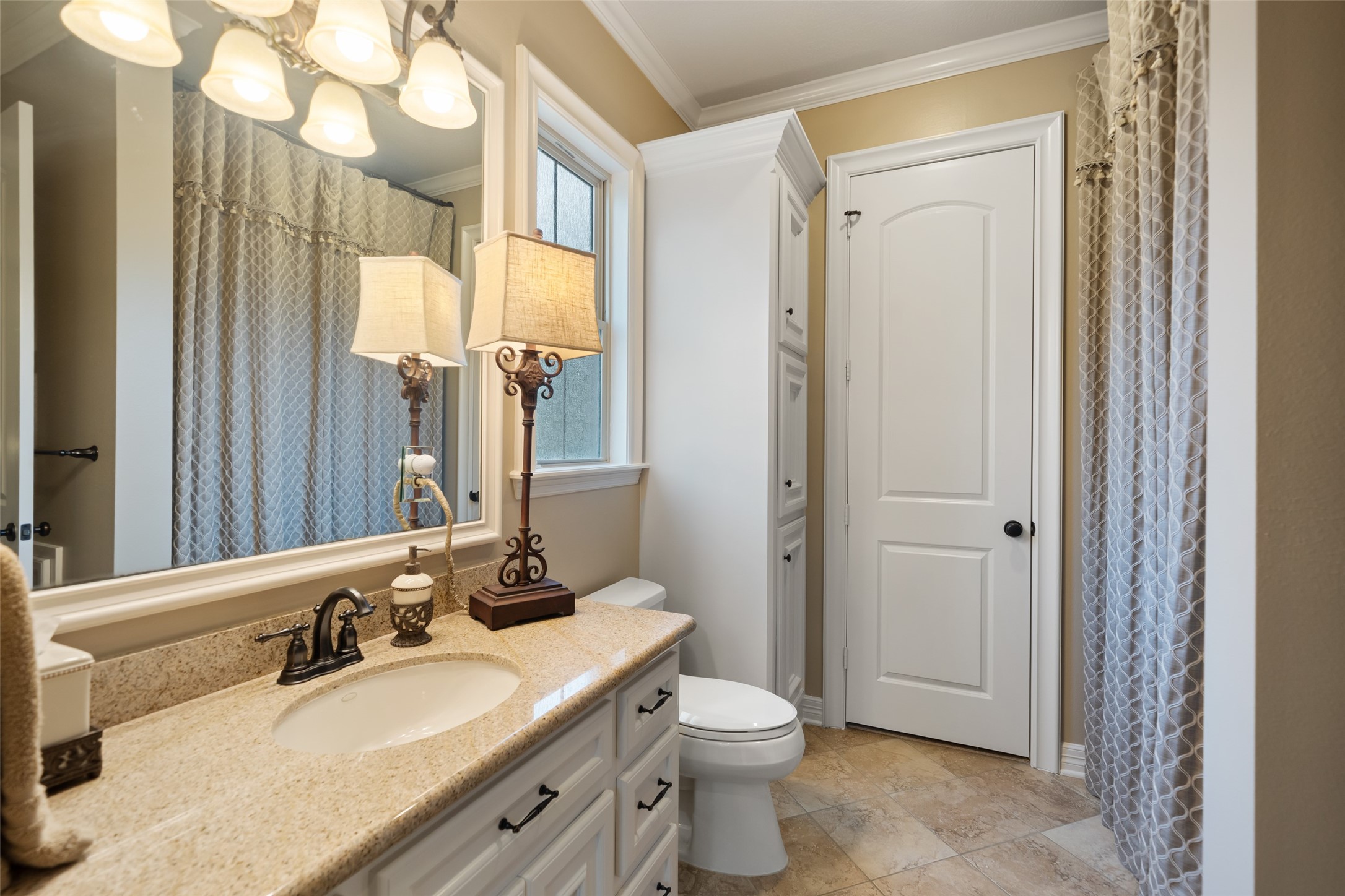 59 East Ambassador Bend Spring, TX 77382 - Photo 33 of 48 This en-suite secondary bathroom features a tub-shower combo, ample countertop space, and built-in storage, offering both comfort and practicality.