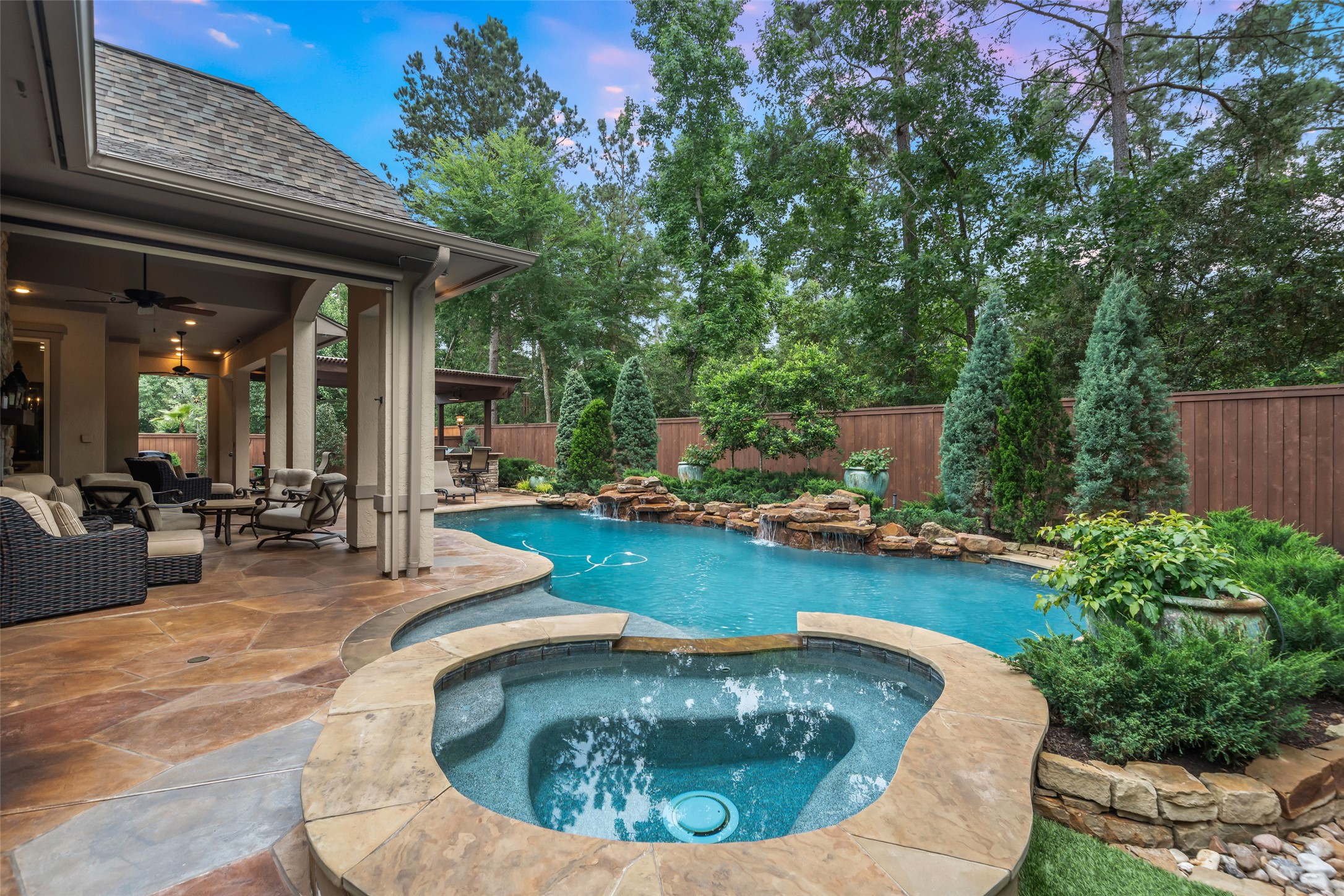 59 East Ambassador Bend Spring, TX 77382 - Photo 34 of 48 This stunning pool area showcases thoughtful upgrades and resort-style features throughout. Equipped with recent pool equipment, an automatic water-fill system, and an in-floor cleaning system with spray heads, maintenance is effortless. The space is elevated by a relaxing spa, and natural rock waterfall features creating a resort-like feel.
