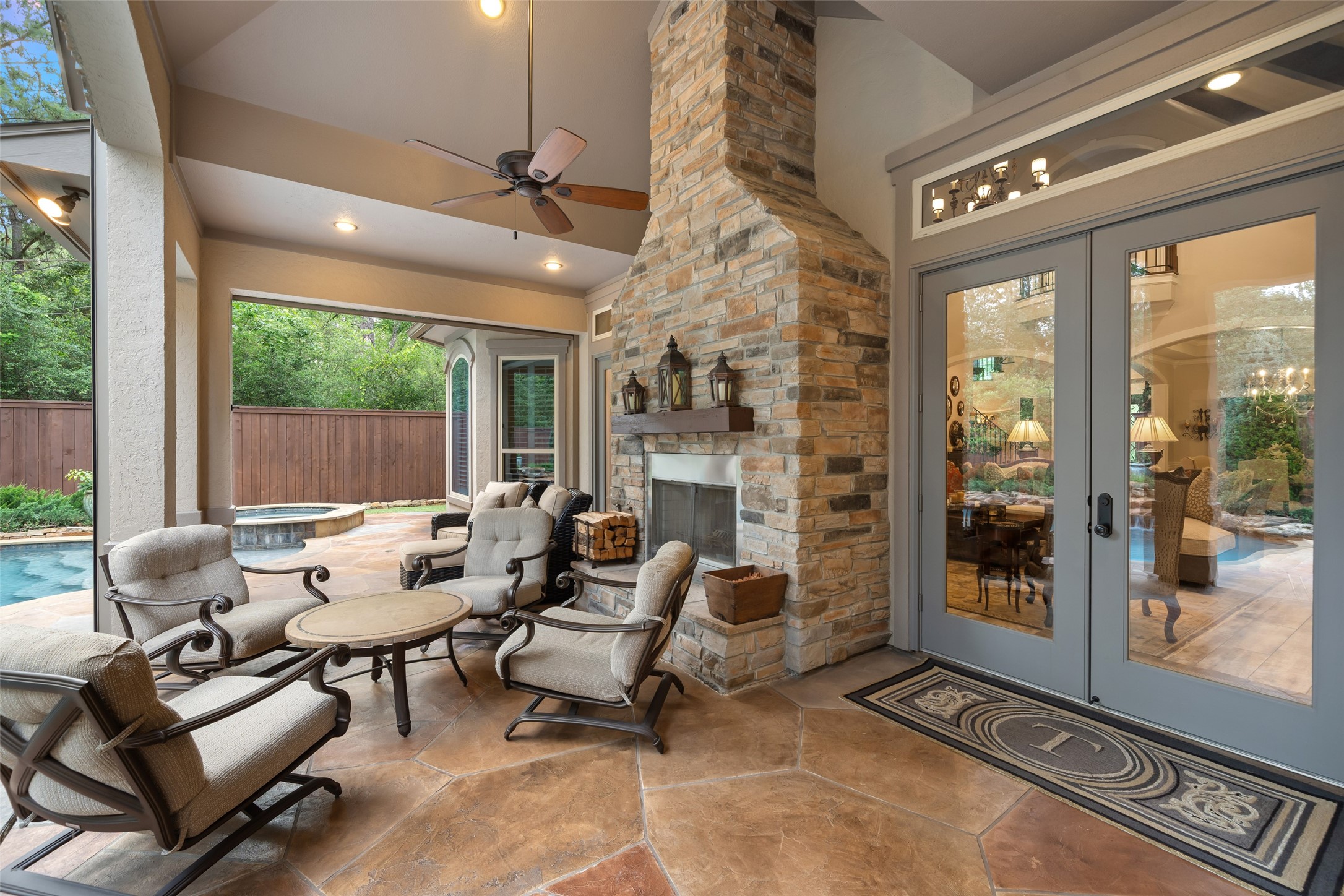 59 East Ambassador Bend Spring, TX 77382 - Photo 36 of 48 This backyard patio is a true showstopper, anchored by a true woodburning floor-to-ceiling stone fireplace that creates a warm and inviting focal point. The soaring design adds a sense of grandeur to space. Ideal for entertaining or relaxing, this patio seamlessly blends comfort and style with a striking architectural presence.
