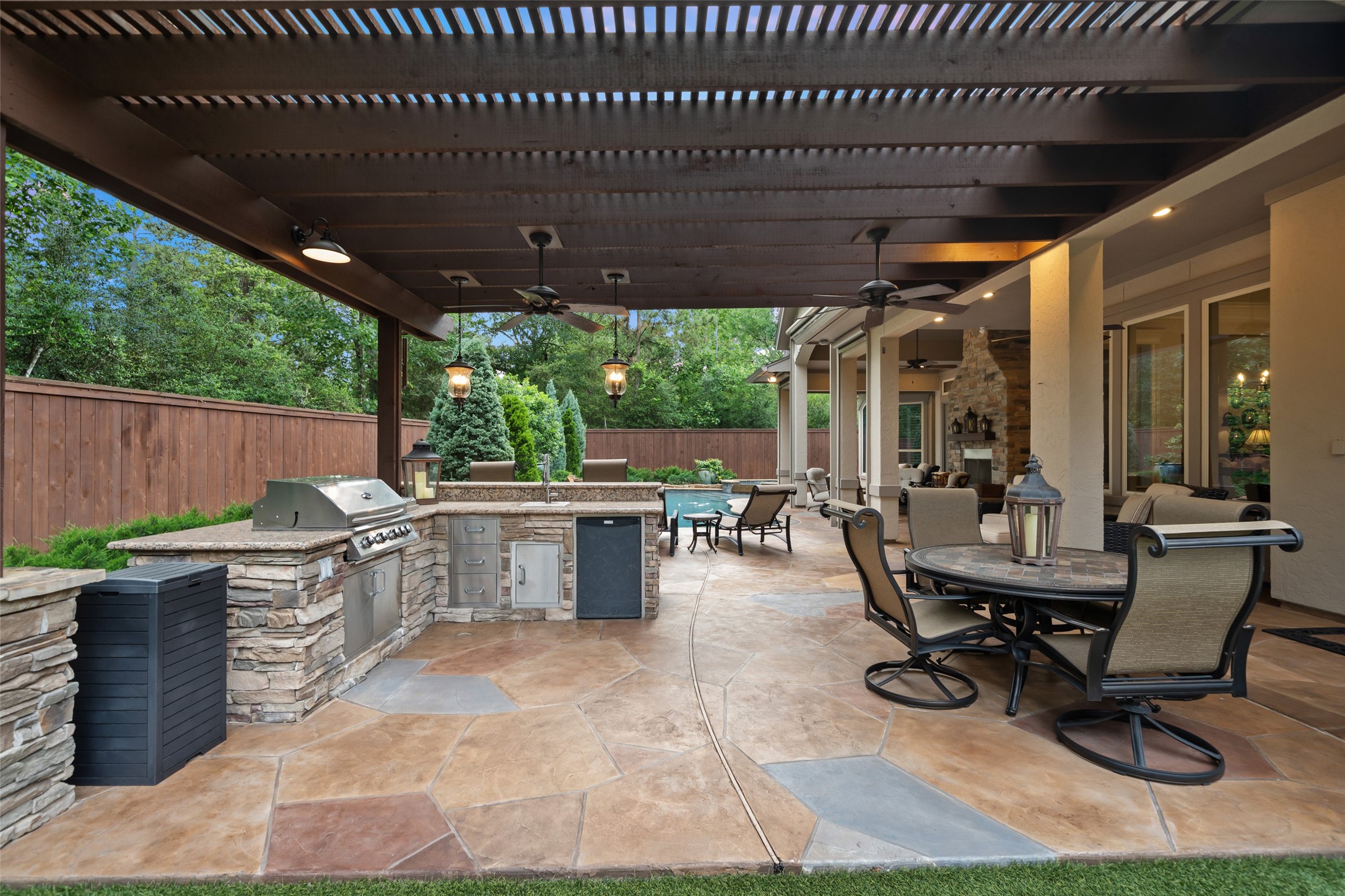 59 East Ambassador Bend Spring, TX 77382 - Photo 40 of 48 The outdoor patio features a fully covered kitchen designed for both style and functionality. Equipped with a new RCS gas grill and side burner, a sleek stainless-steel sink, stainless steel cabinetry and drawers, refrigerator and updated LED pendant lighting, this space is perfect for entertaining.