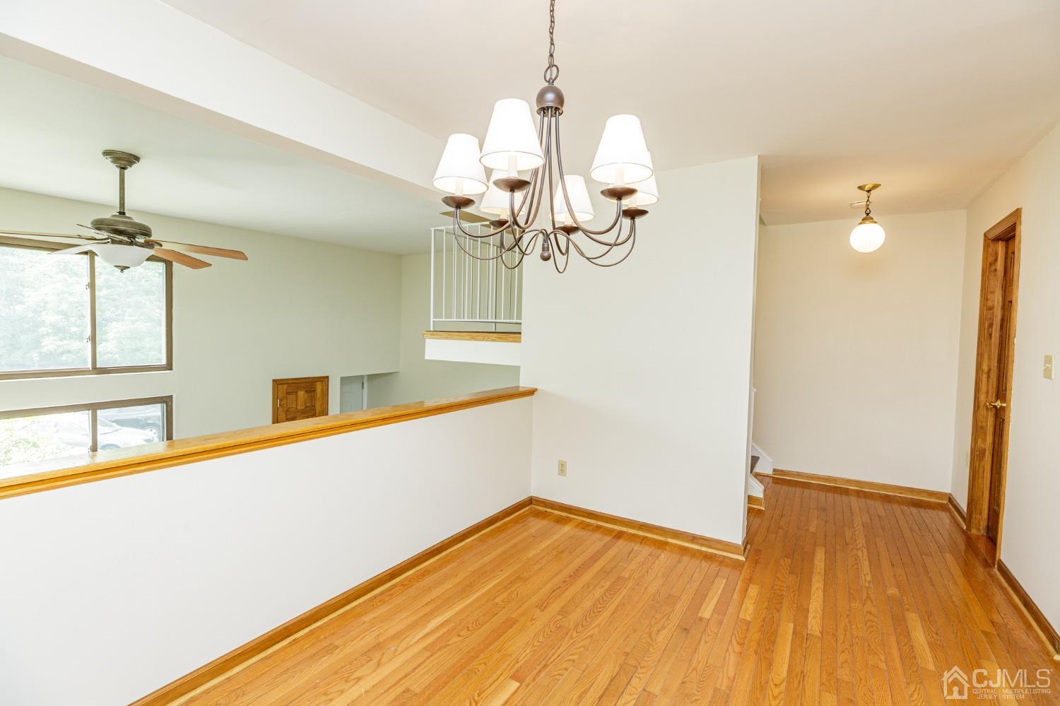 335 Alpine Court, Unit 35 Stanhope, NJ 07874 - Photo 11 of 32 a view of a room with wooden floor and chandelier