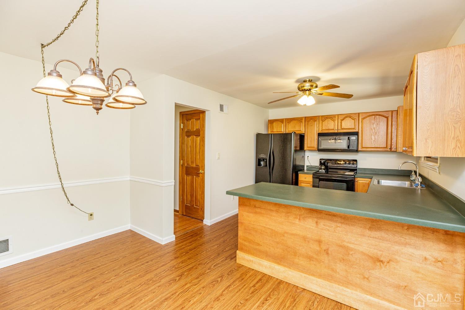 335 Alpine Court, Unit 35 Stanhope, NJ 07874 - Photo 13 of 32 a view of a living room and kitchen with wooden floor