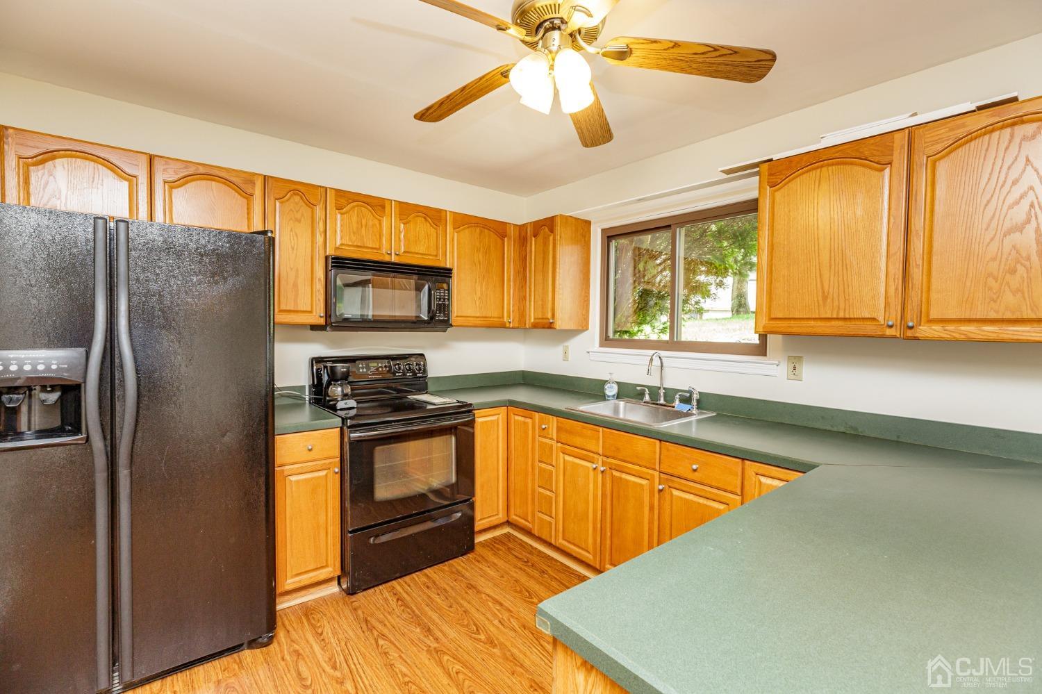 335 Alpine Court, Unit 35 Stanhope, NJ 07874 - Photo 15 of 32 a kitchen with stainless steel appliances granite countertop a sink a stove and a refrigerator