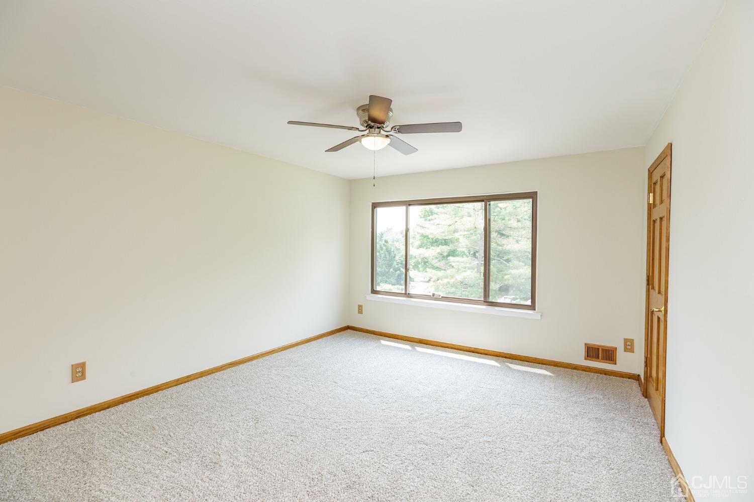 335 Alpine Court, Unit 35 Stanhope, NJ 07874 - Photo 18 of 32 an empty room with windows and ceiling fan