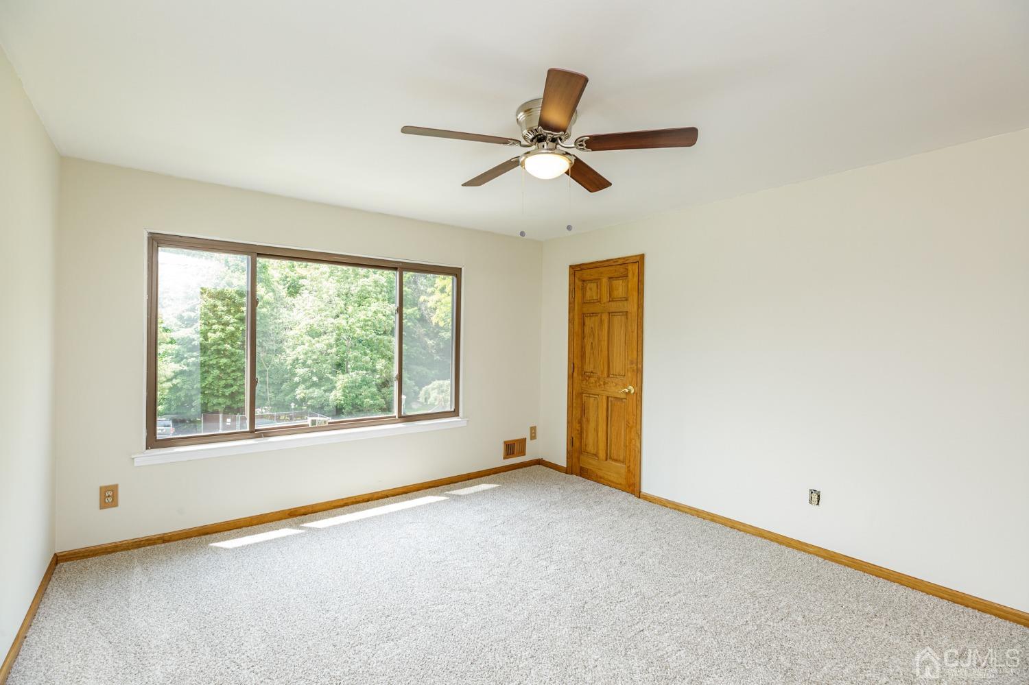 335 Alpine Court, Unit 35 Stanhope, NJ 07874 - Photo 19 of 32 a view of an empty room with a window