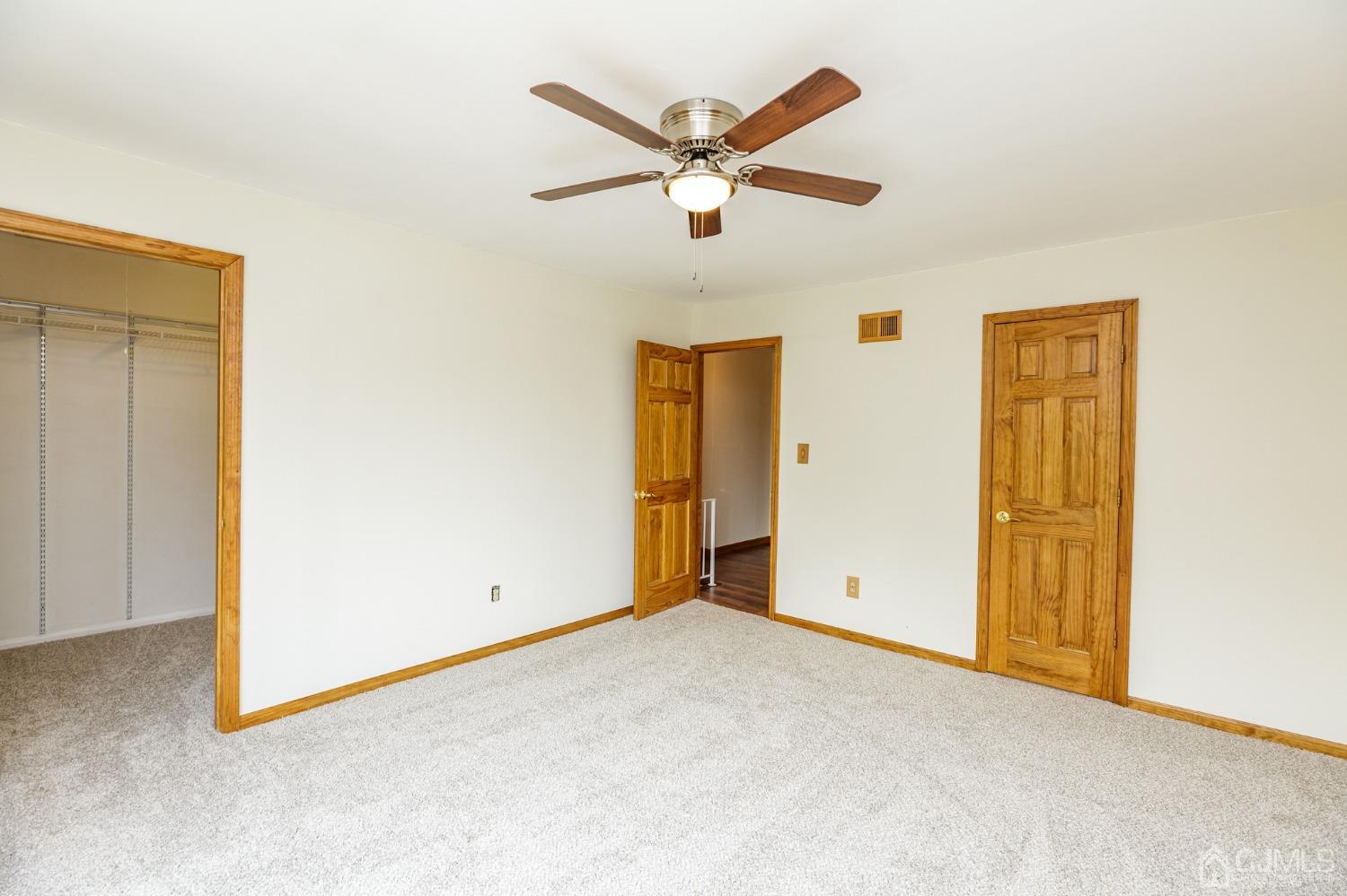 335 Alpine Court, Unit 35 Stanhope, NJ 07874 - Photo 20 of 32 an empty room with closet and ceiling fan