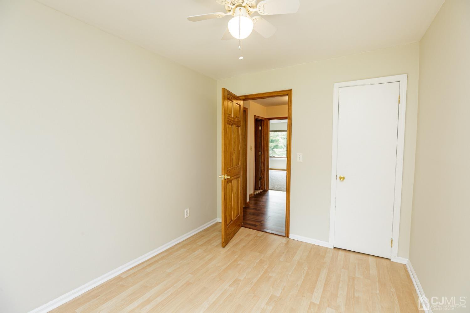 335 Alpine Court, Unit 35 Stanhope, NJ 07874 - Photo 24 of 32 a view of an empty room with window and a ceiling fan