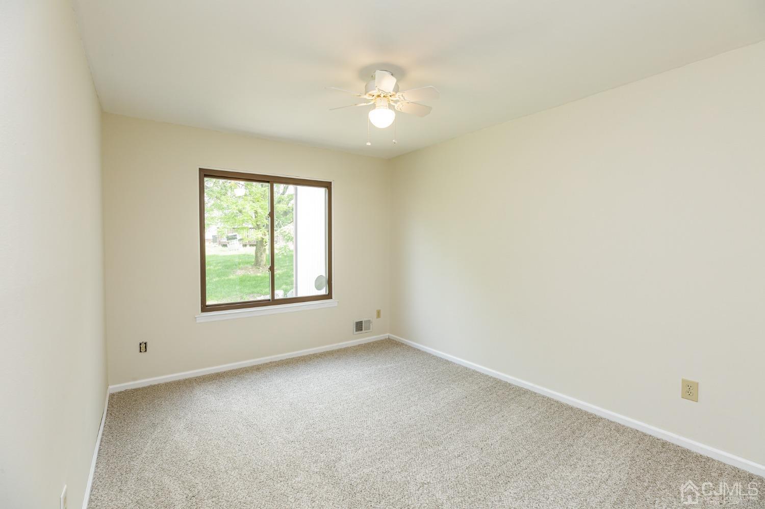 335 Alpine Court, Unit 35 Stanhope, NJ 07874 - Photo 27 of 32 an empty room with a window