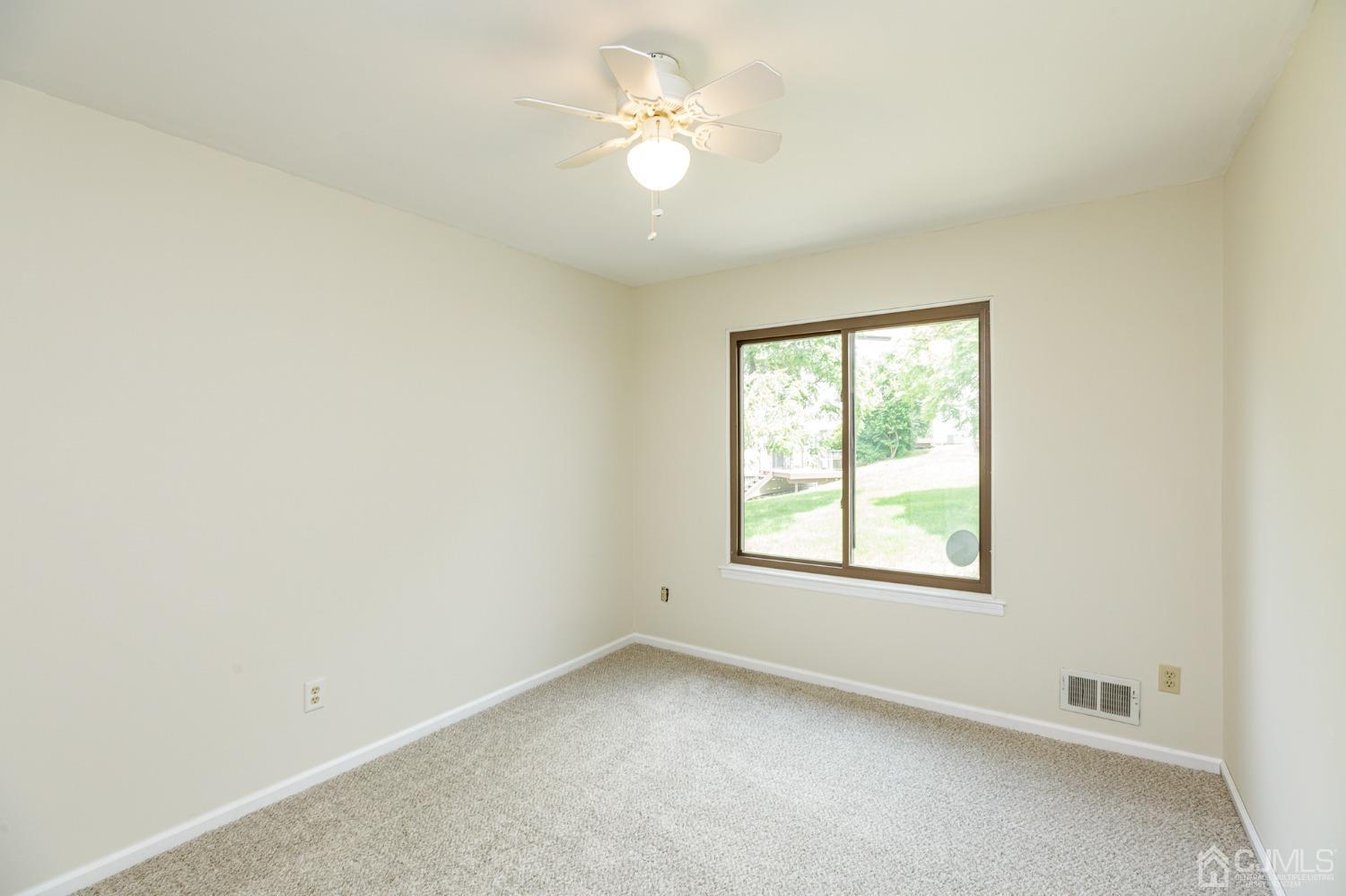 335 Alpine Court, Unit 35 Stanhope, NJ 07874 - Photo 28 of 32 an empty room with a window and a fan