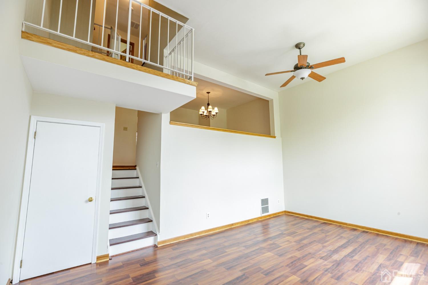335 Alpine Court, Unit 35 Stanhope, NJ 07874 - Photo 3 of 32 a view of a room with stairs and wooden floor