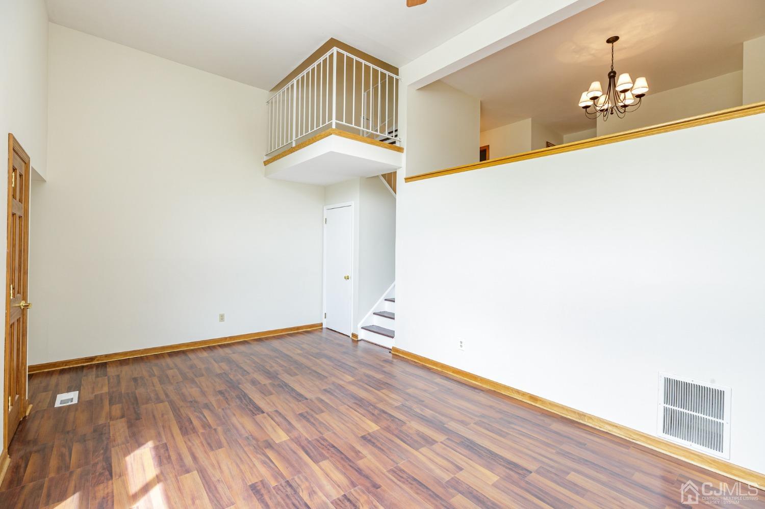 335 Alpine Court, Unit 35 Stanhope, NJ 07874 - Photo 5 of 32 a view of an empty room with wooden floor