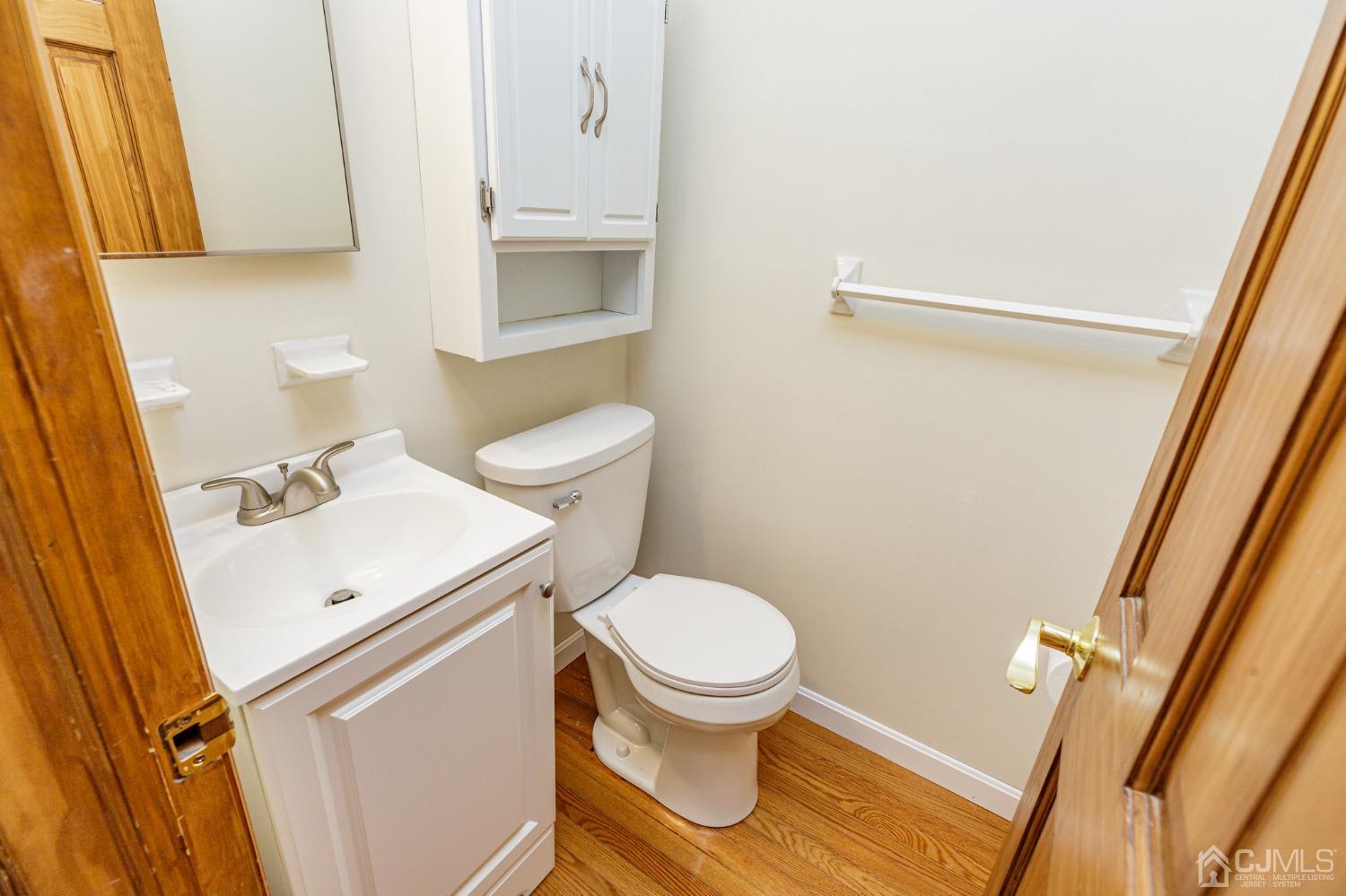 335 Alpine Court, Unit 35 Stanhope, NJ 07874 - Photo 7 of 32 a white toilet sitting next to a bathroom sink