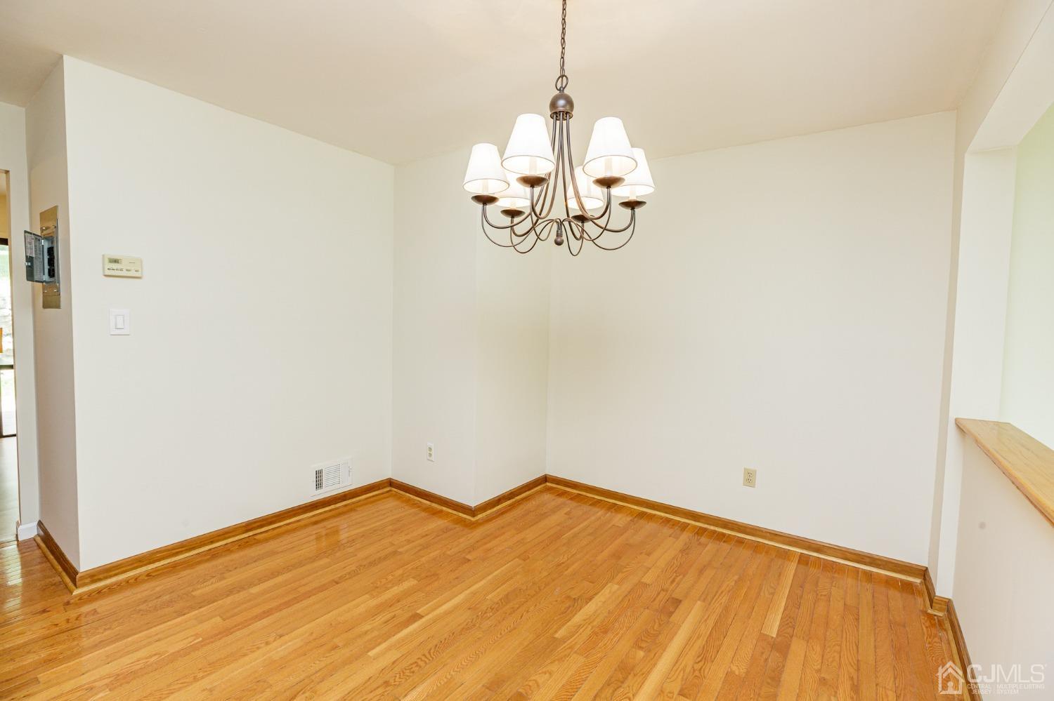 335 Alpine Court, Unit 35 Stanhope, NJ 07874 - Photo 9 of 32 a view of a room with wooden floor and ceiling fan