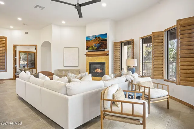 a living room with fireplace furniture and a flat screen tv