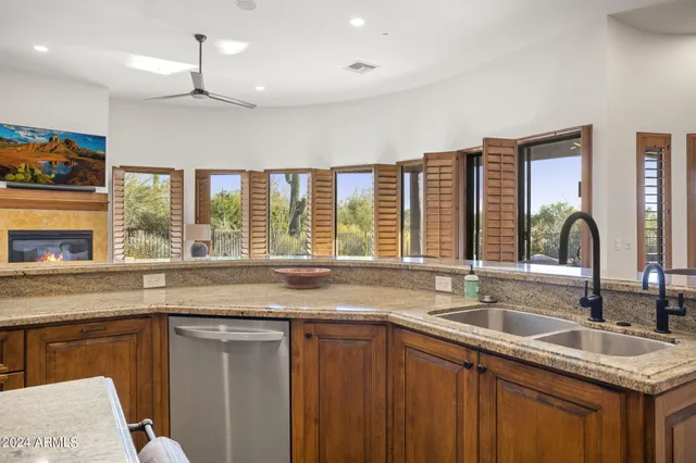 a living room with furniture and a ceiling fan
