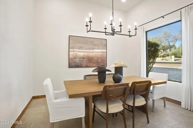 a view of a kitchen with refrigerator and wooden floor