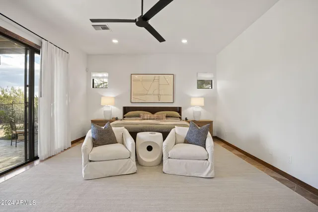 a bathroom with a granite countertop sink a toilet a mirror and bathtub