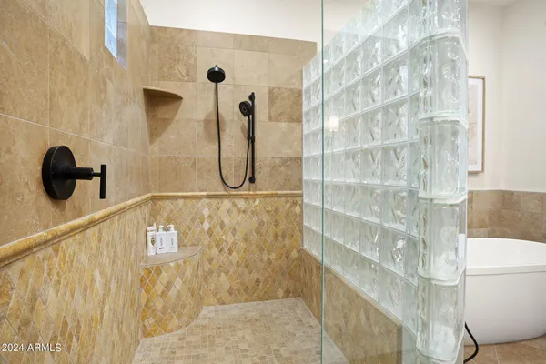 a bathroom with a granite countertop sink toilet a mirror and shower
