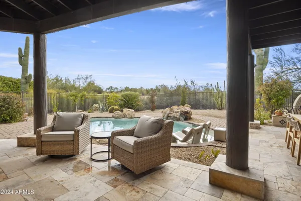 a view of roof deck with couches and city view