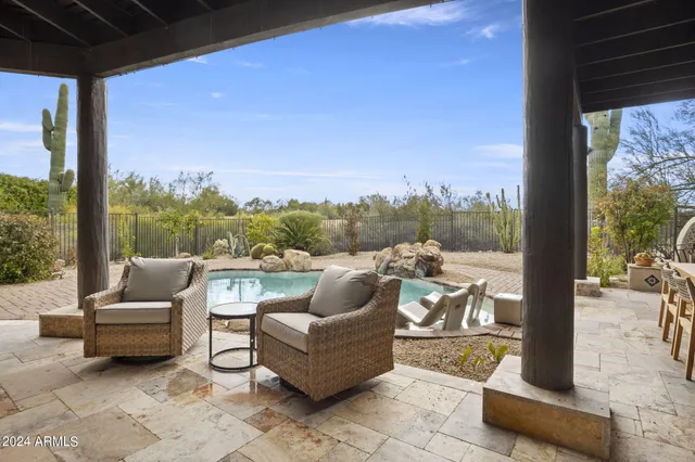 a view of roof deck with couches and city view