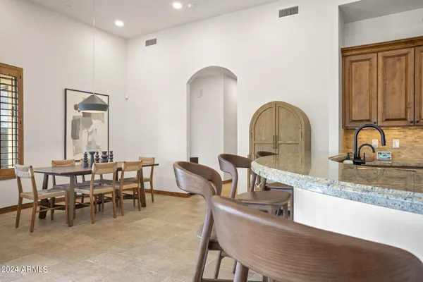 a kitchen with stainless steel appliances granite countertop a sink and a refrigerator
