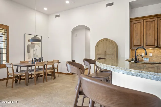 a kitchen with stainless steel appliances granite countertop a sink and a refrigerator