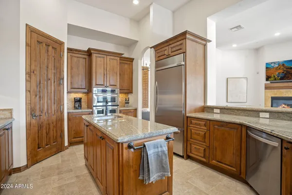 a kitchen with stainless steel appliances granite countertop a sink stove and cabinets